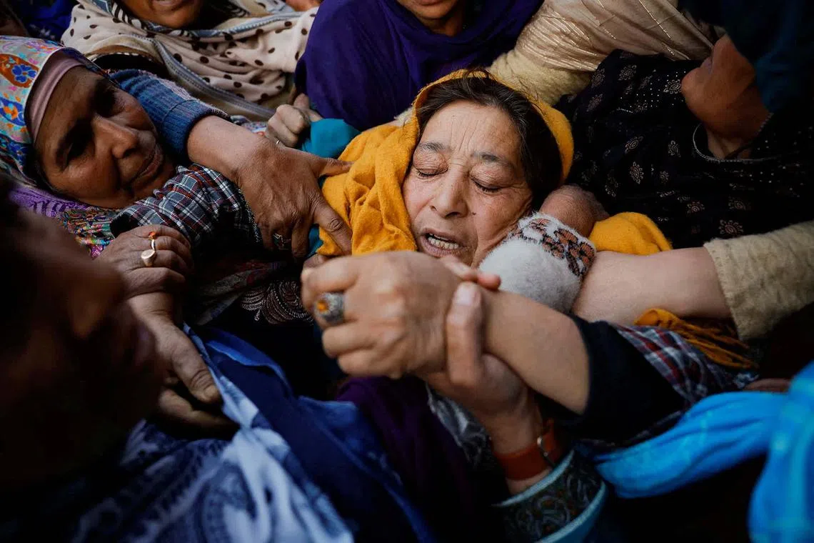 Relatives console the mother of Abida Kousar, a civilian, who according to local media succumbed to her injuries after she was wounded in a grenade explosion on Nov 3 in a market area, in Srinagar, during her funeral in North Kashmir's Bandipora district, Nov 12, 2024. 