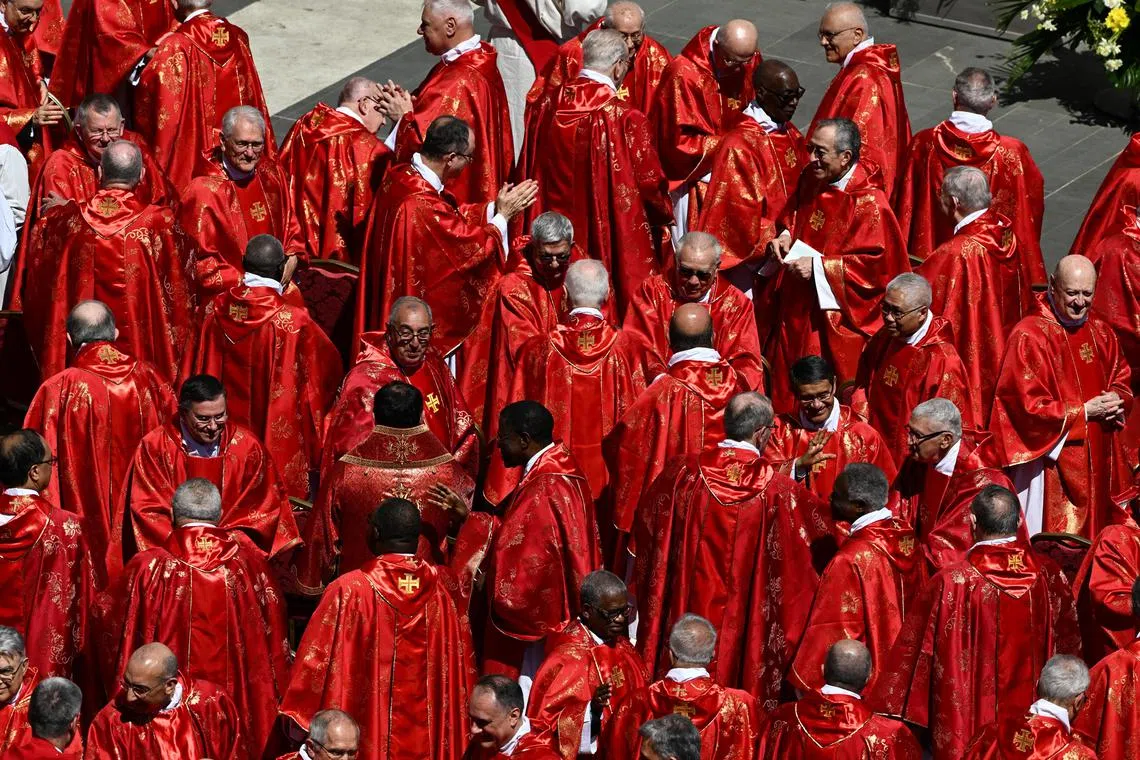 Members of the clergy, including Singapore's Cardinal William Goh (middle, second from right) sharing the sign of peace during the funeral Mass of Pope Francis in St. Peter's Square at the Vatican, April 26, 2025. 