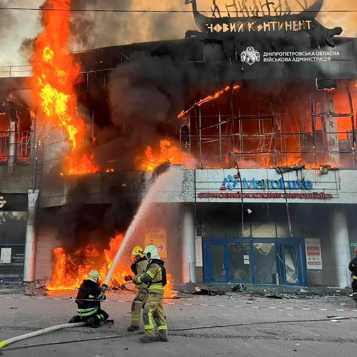 Ukrainian firefighters working at the site of a Russian strike on a shopping mall in a residential area in Dnipro, Ukraine, on Sept 19.