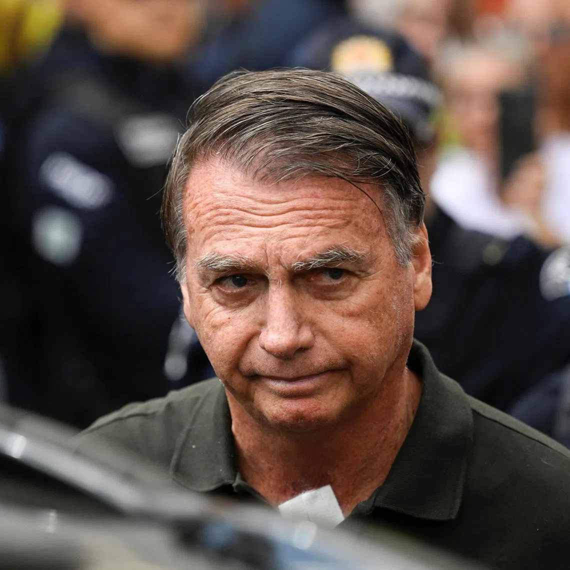 FILE PHOTO: Former Brazilian President Jair Bolsonaro leaves the hospital where he went to undergo a skin surgery procedure, authorized by Supreme Court Justice Alexandre de Moraes, leaving the house arrest after being convicted by a Supreme Court majority of plotting a coup to remain in power after losing the 2022 election, in Brasilia, Brazil, September 14, 2025. REUTERS/Mateus Bonomi/ File Photo