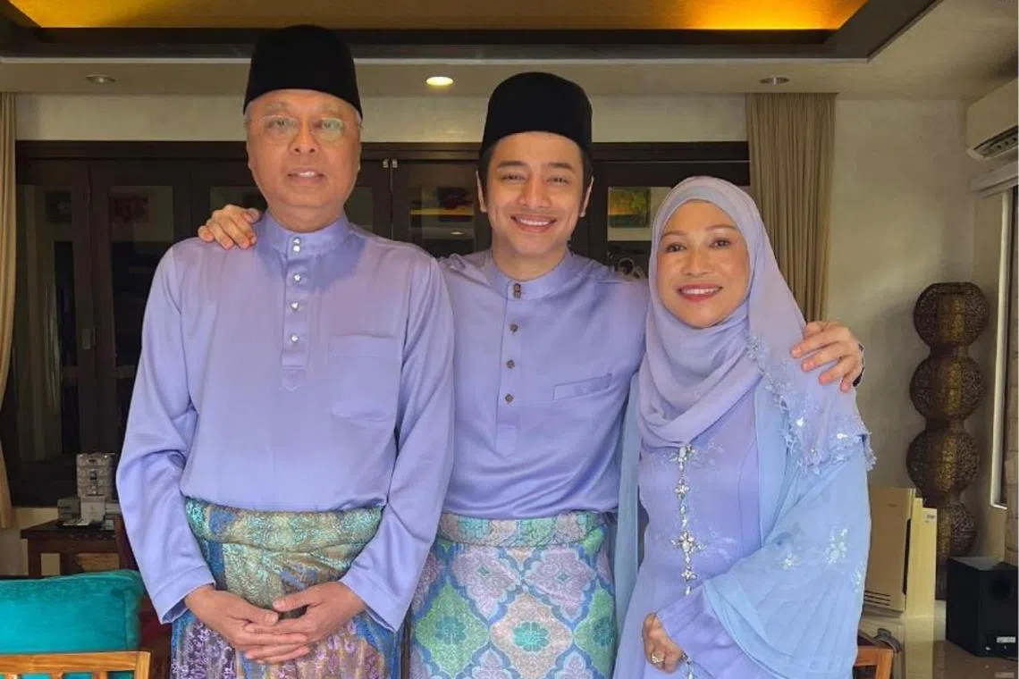 Malaysian actor and singer Dafi flanked by his parents Datuk Seri Ismail Sabri Yaakob and Datin Seri Muhaini Zainal Abidin.