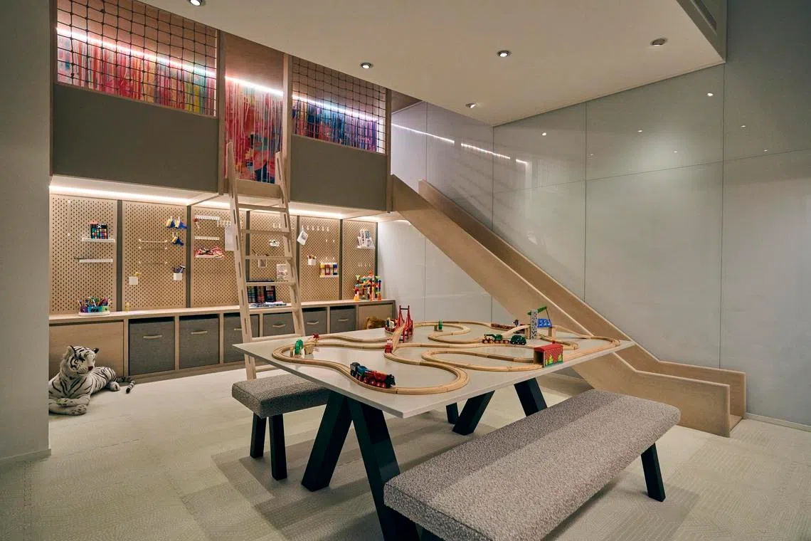 An activity table and slide sit at the heart of the children’s playroom.