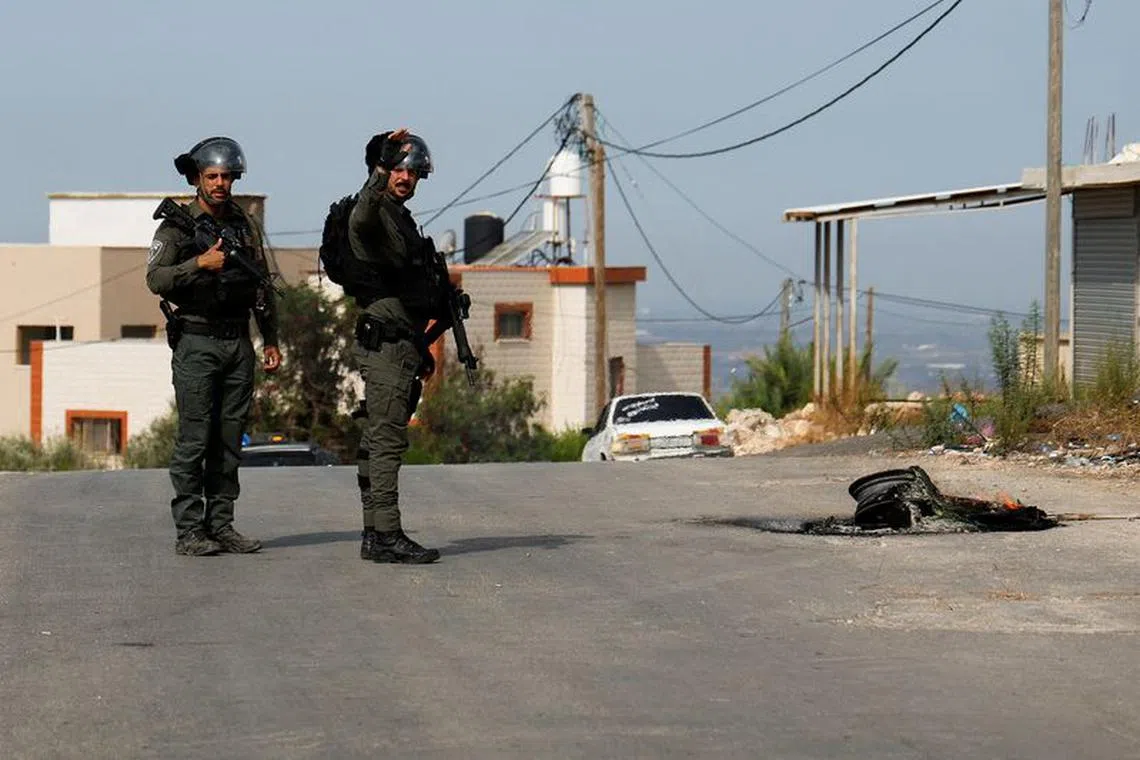 FILE PHOTO: Members of the Israeli forces stand guard during clashes with Palestinians, near Tulkarm, in the Israeli-occupied West Bank, October 5, 2023. REUTERS/Raneen Sawafta/File Photo