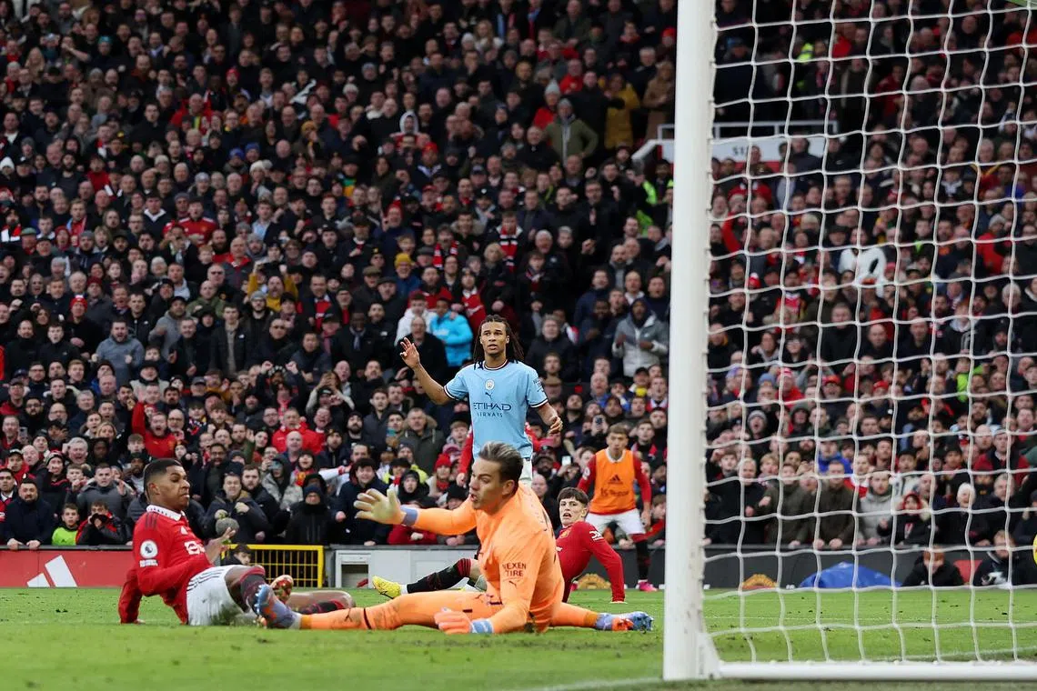 Manchester United's Marcus Rashford scoring their second goal past Manchester City's Ederson.