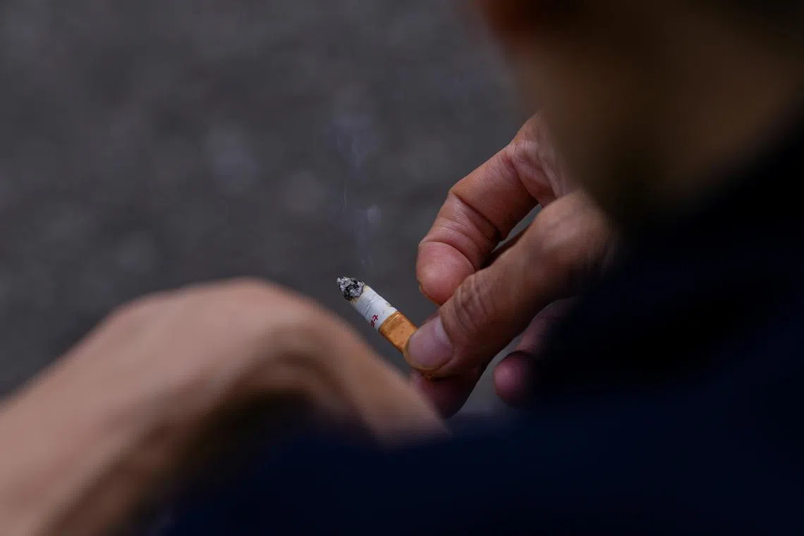 FILE PHOTO: A man holds a cigarette in his hands in London, Britain April 11, 2023. REUTERS/Maja Smiejkowska/File Photo