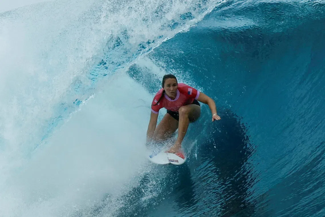 FILE PHOTO: Paris 2024 Olympics - Surfing - Women's Round 1 - Heat 8 - Teahupo'o, Tahiti, French Polynesia - July 27, 2024. Carissa Moore of United States rides in the barrel. Ben Thouard/Pool via REUTERS/File Photo