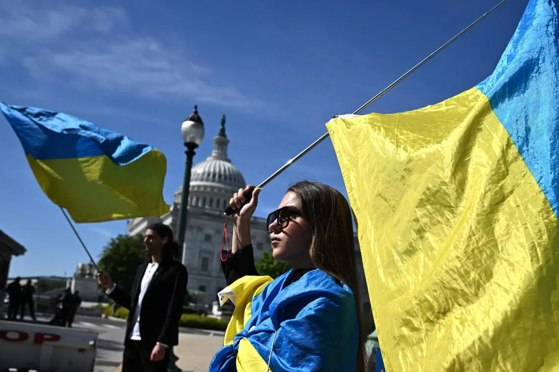 Activists waving Ukrainian flags outside the US Capitol in Washington, DC, on April 23, 2024.