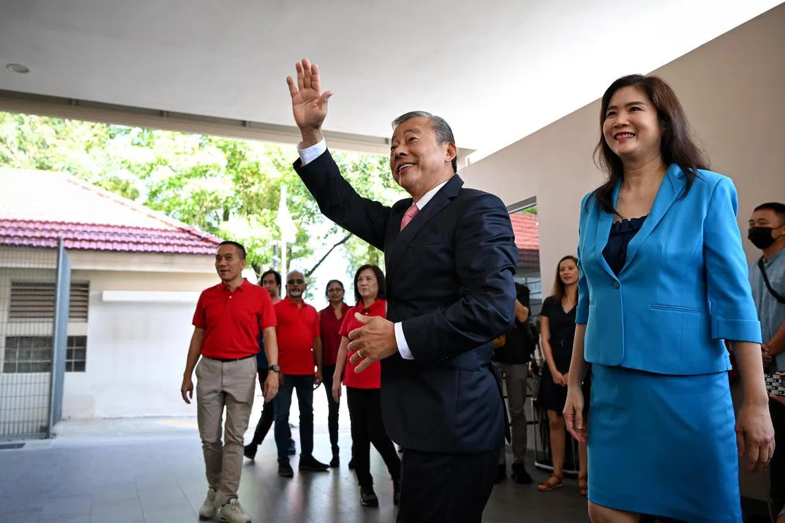 Mr George Goh (waving, with his wife Lysa Sumali) said his team advised him that the "stable of companies which he manages, taken together, would enable him to qualify".