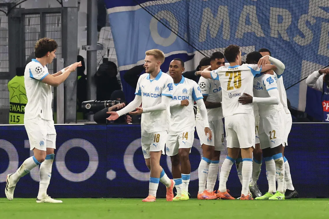 Soccer Football - UEFA Champions League - Olympique de Marseille v Newcastle United - Orange Velodrome, Marseille, France - November 25, 2025  Olympique de Marseille's Pierre-Emerick Aubameyang celebrates scoring their second goal with teammates REUTERS/Manon Cruz