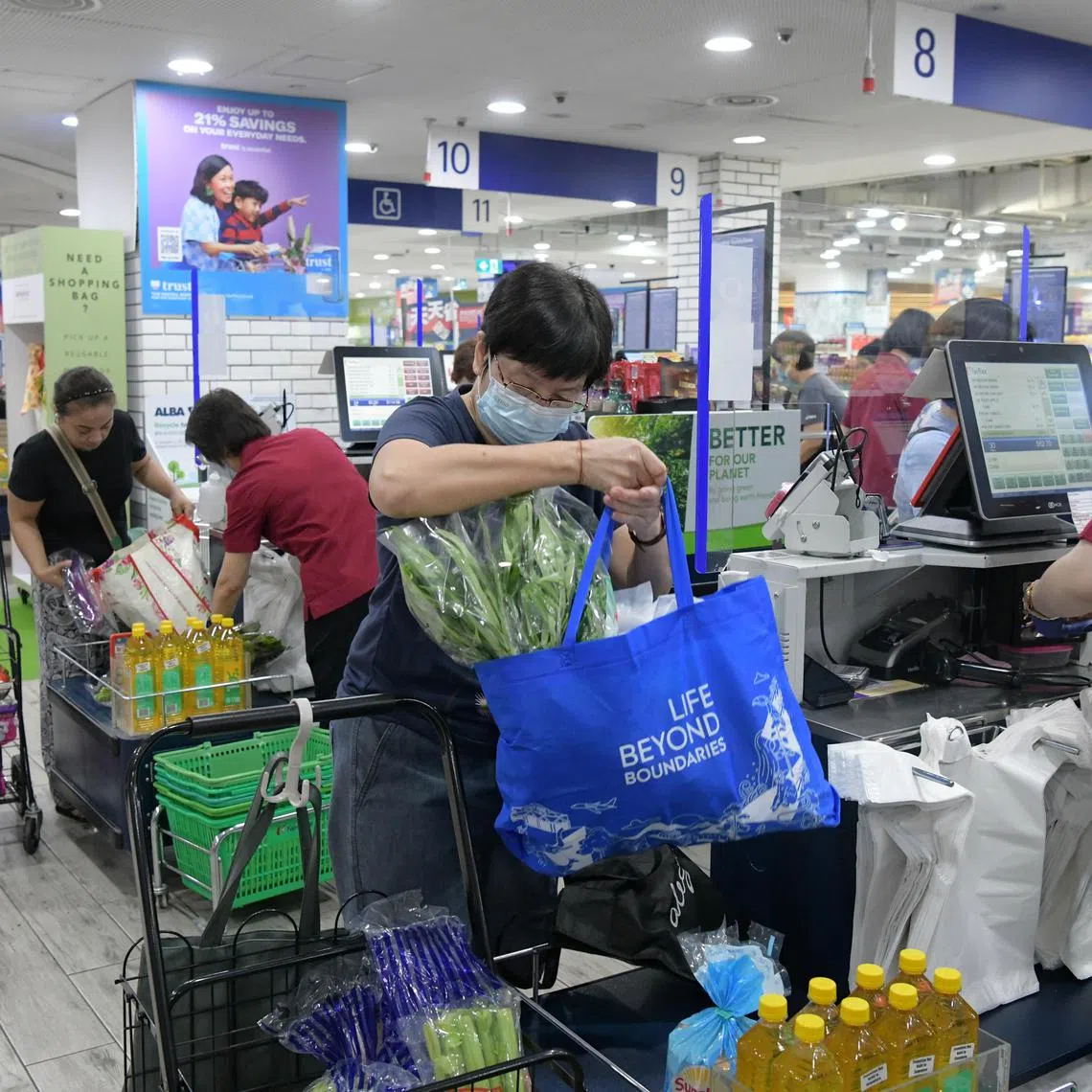 Customers at an NTUC outlet in Northpoint City using their own bags while buying groceries, on July 3, 2023.