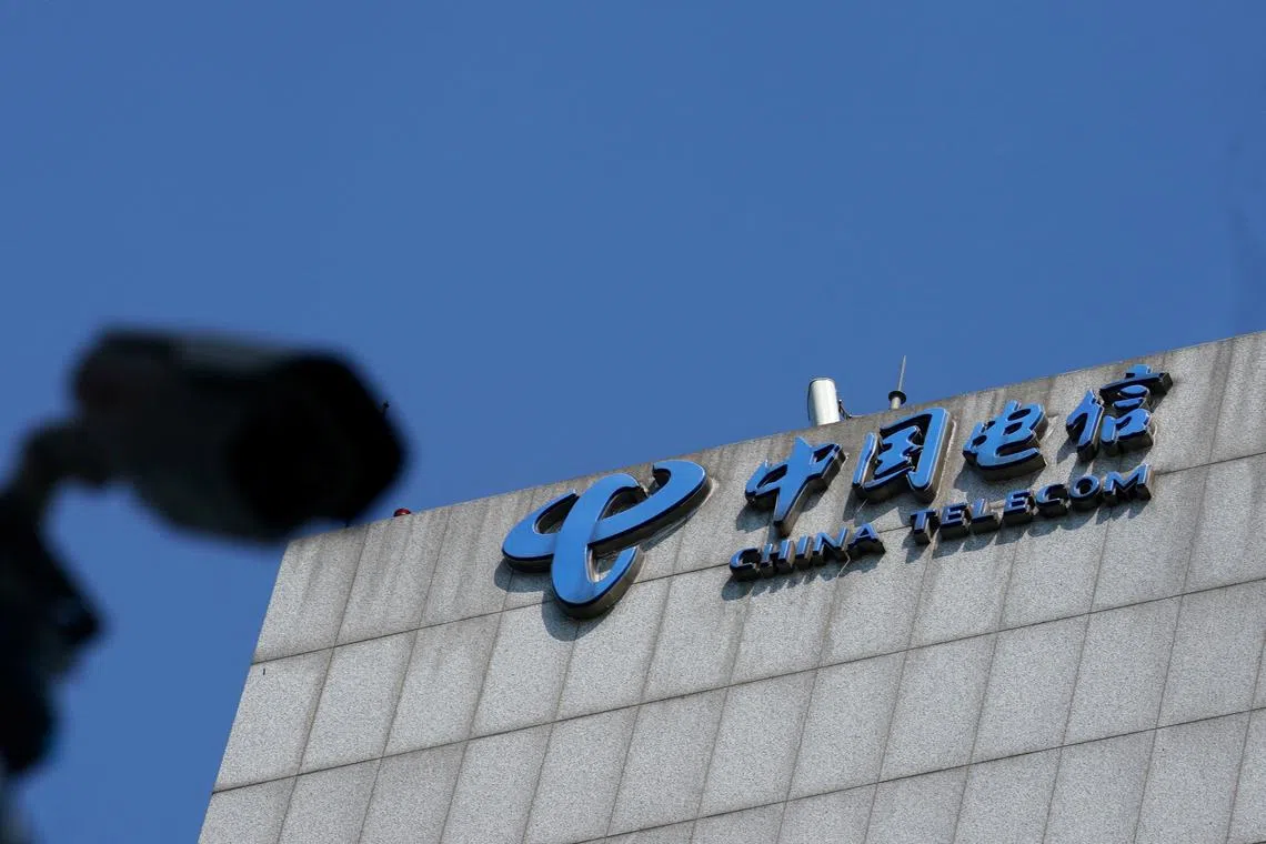FILE PHOTO: A sign of China Telecom is pictured near a security camera in Beijing, China August 11, 2020. Picture taken August 11, 2020. REUTERS/Tingshu Wang/File Photo