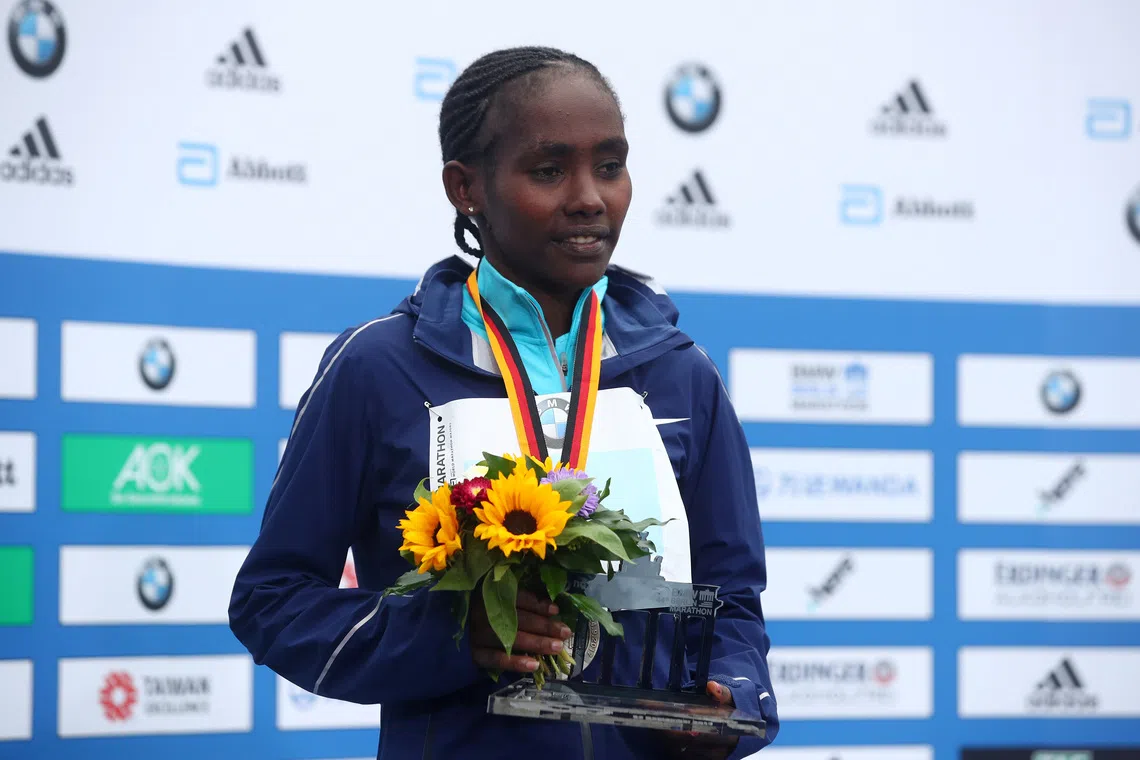 Athletics - Berlin Marathon - Berlin, Germany - September 24, 2017   Ethiopia's Ruti Aga celebrates with a trophy after finishing second in the Women's race   REUTERS/Michael Dalder