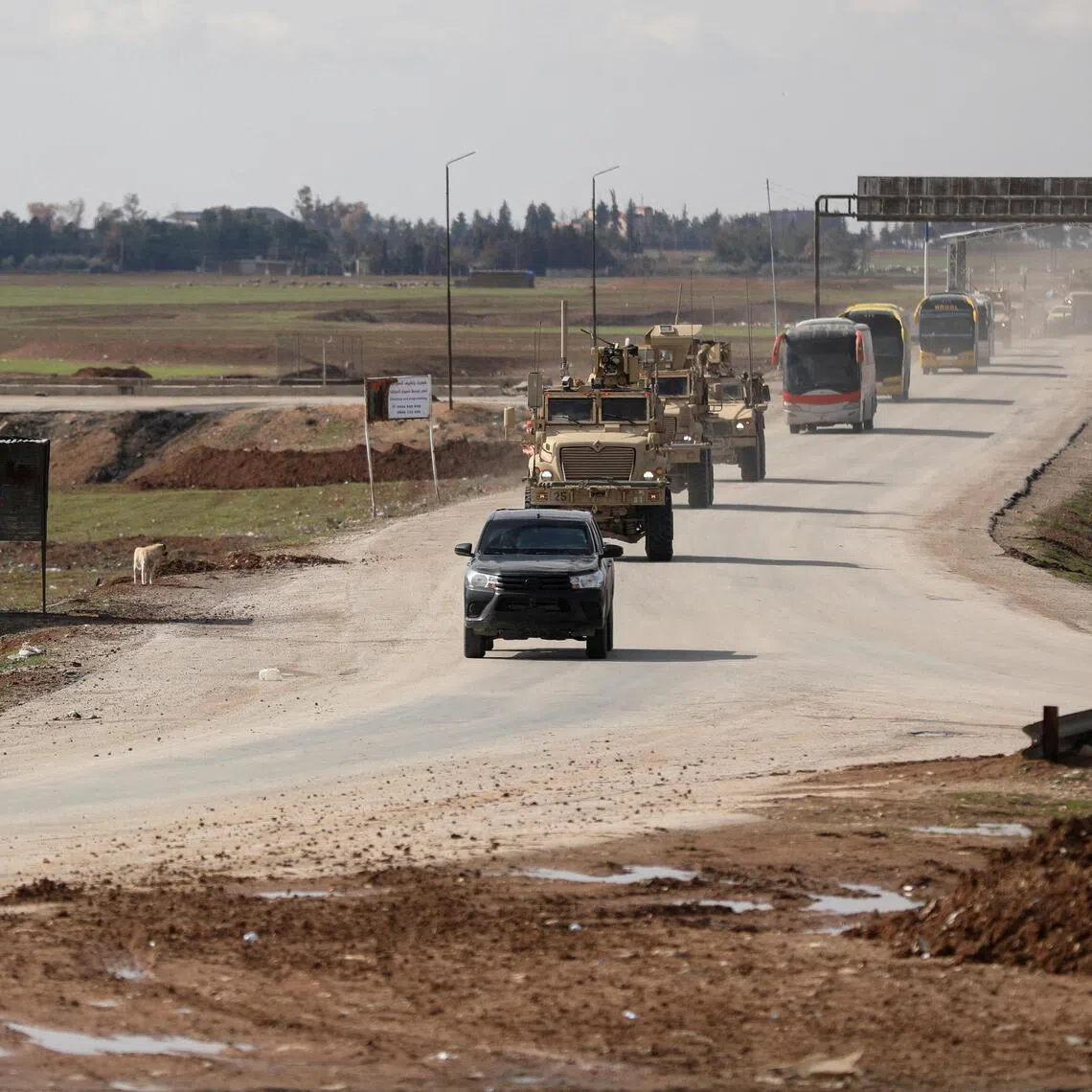 US military vehicles moving ahead of buses transporting Islamic State detainees from Syria to Iraq, according to a security source from the Syrian Democratic Forces, in Qamishli, Syria, on Feb 8, 2026.     
