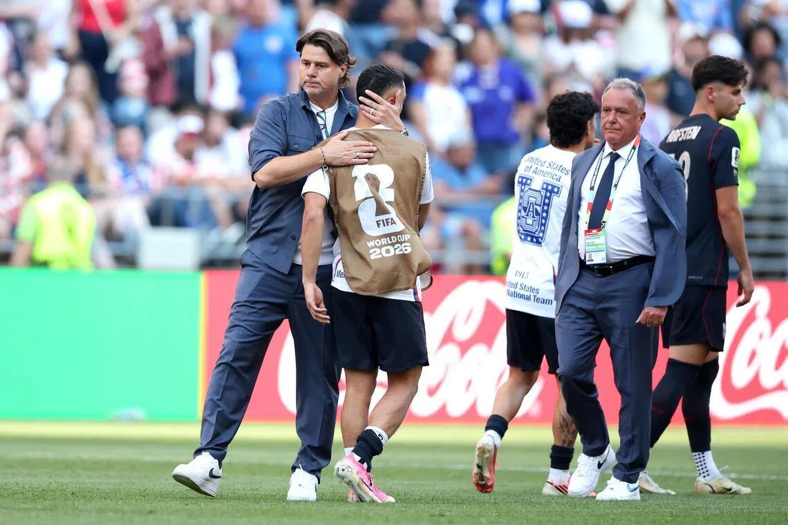 USA coach Mauricio Pochettino and his team  after losing 4-1 to Belgium at the World Cup on July 6.