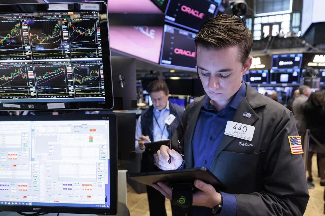 Traders work on the floor of the New York Stock Exchange, in New York City.