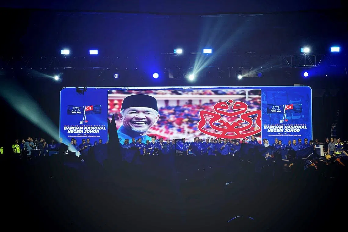 Barisan Nasional candidates singing UMNO’s theme song at the party campaign launch on June 7.