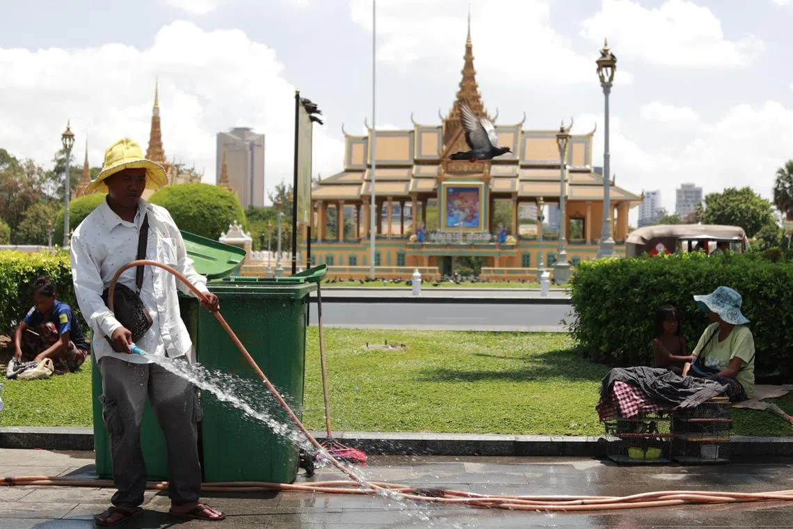 A man spraying water at a park in front of the Royal Palace in Phnom Penh, Cambodia on April 26. 