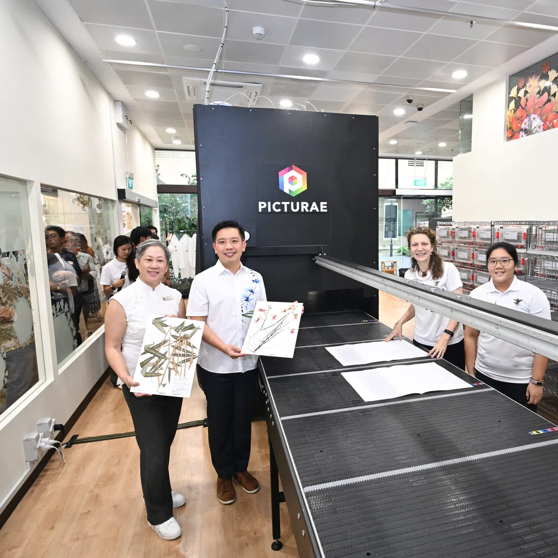 Minister of State for National Development Alvin Tan (second from left) digitising a Papilionanthe Miss Joaquim (Vanda Miss Joaquim) specimen on Oct 28.