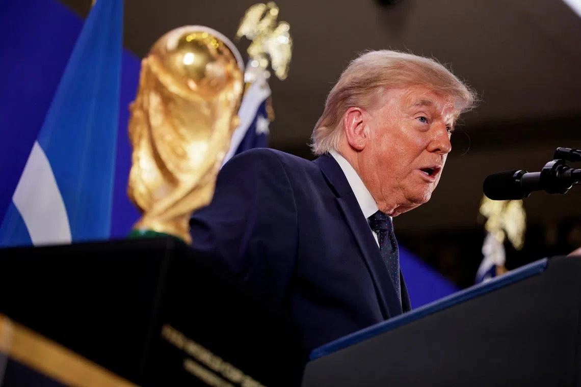 US President Donald Trump speaks while standing next to the FIFA World Cup Trophy in New York City on July 17.
