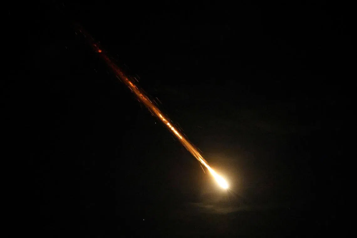 A rocket flies in the sky after Iran fired a salvo of ballistic missiles, as seen from Ashkelon, Israel, on Oct 1.