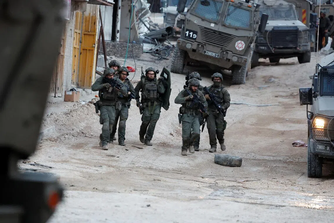 Israeli soldiers operate during a raid, at Nour Shams camp, in Tulkarm.
