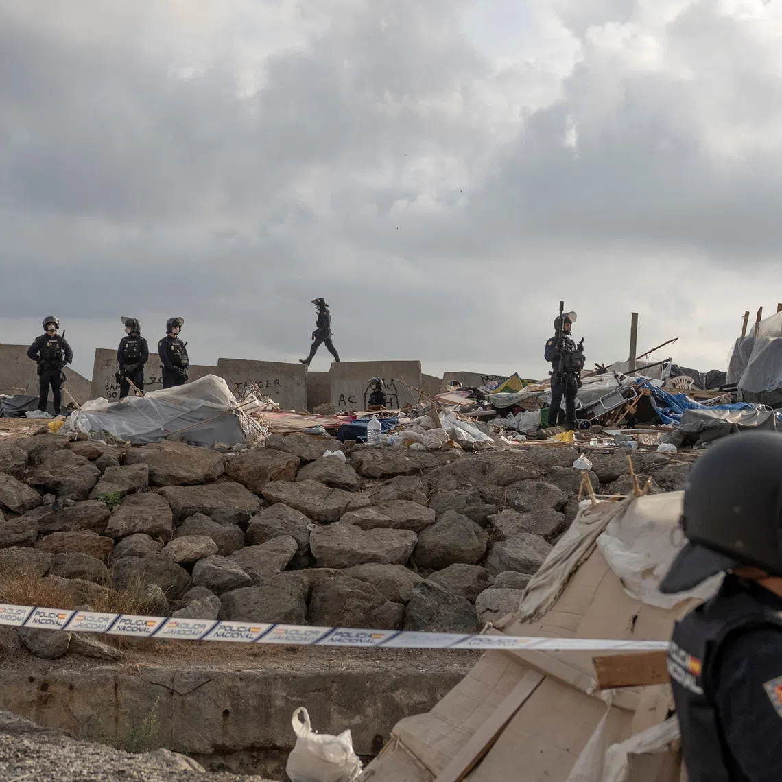 Riot police officers clear part of the makeshift migrant camp at Benitez beach during an operation that, according to police, aims to establish a security perimeter around Ceuta's desalination plant, following the mass crossing of migrants from Morocco, in Ceuta, Spain, September 27, 2026. REUTERS/Manu Brabo