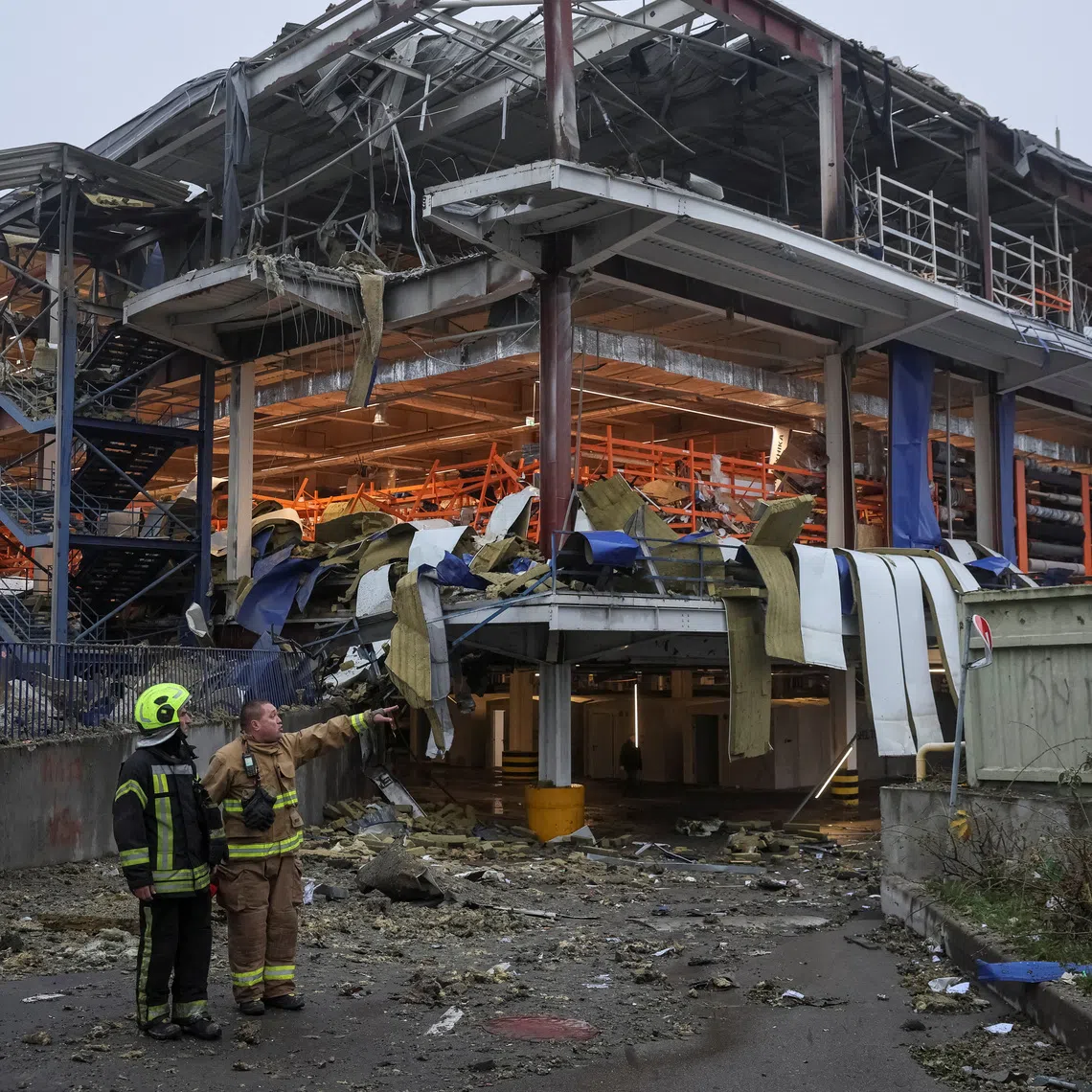Rescuers work at a site of a shopping mall for household items which was hit by a Russian missile attack, amid Russia's attack on Ukraine, in Kyiv, Ukraine October 22, 2026. REUTERS/Gleb Garanich