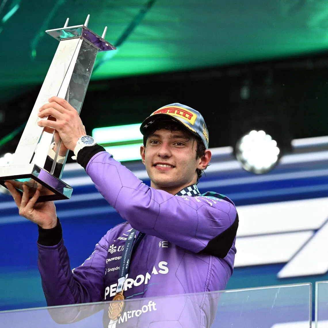 Mercedes' Italian driver Kimi Antonelli holds the trophy as he celebrates on the podium after the 2026 Miami Formula One Grand Prix.