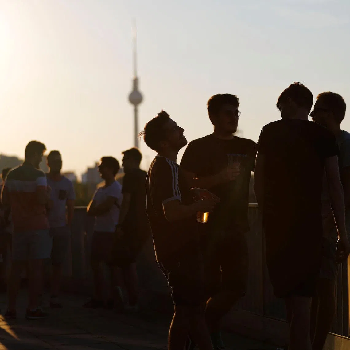 People gather on a terrace in front Berlin's television tower, Germany, July 26, 2018.  REUTERS/Fabrizio Bensch