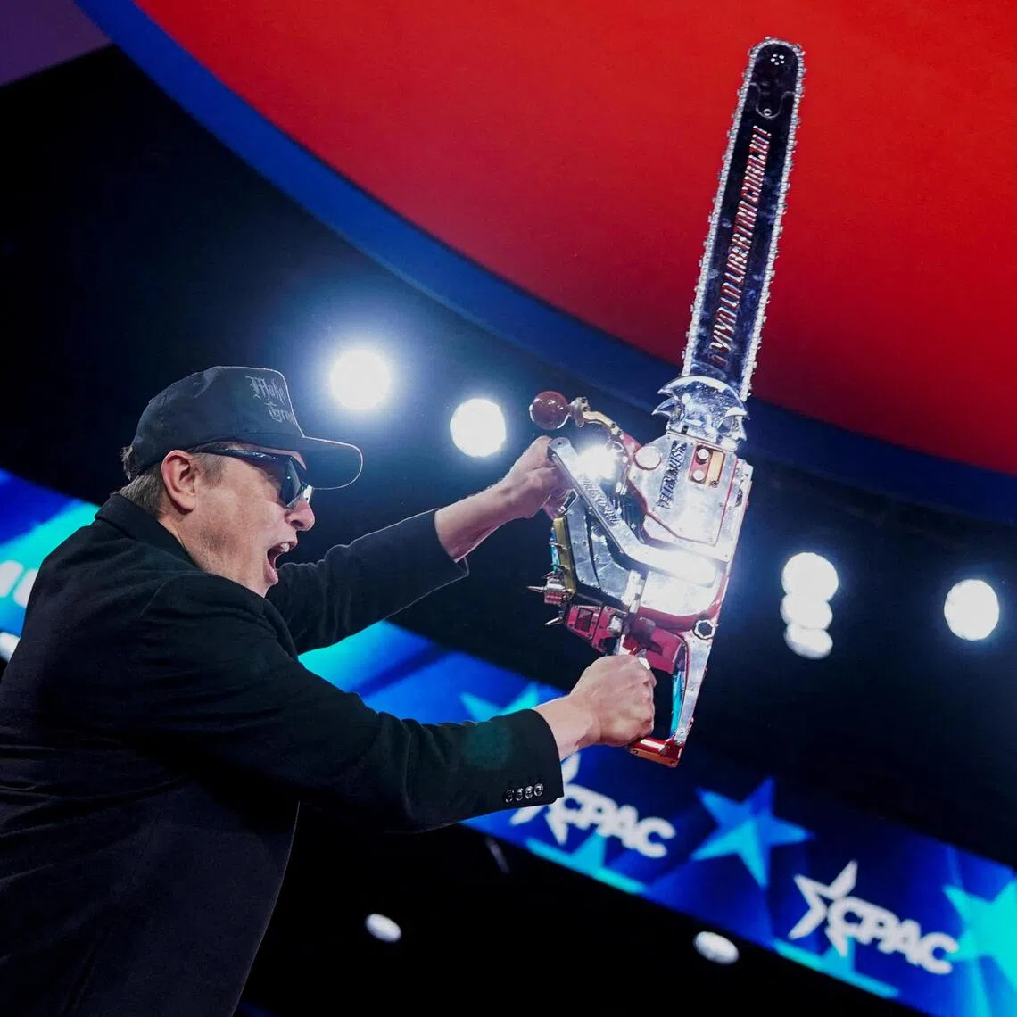 Elon Musk holding up a chainsaw onstage during the Conservative Political Action Conference (CPAC) in National Harbor, Maryland, in the US on Feb 20, 2025.