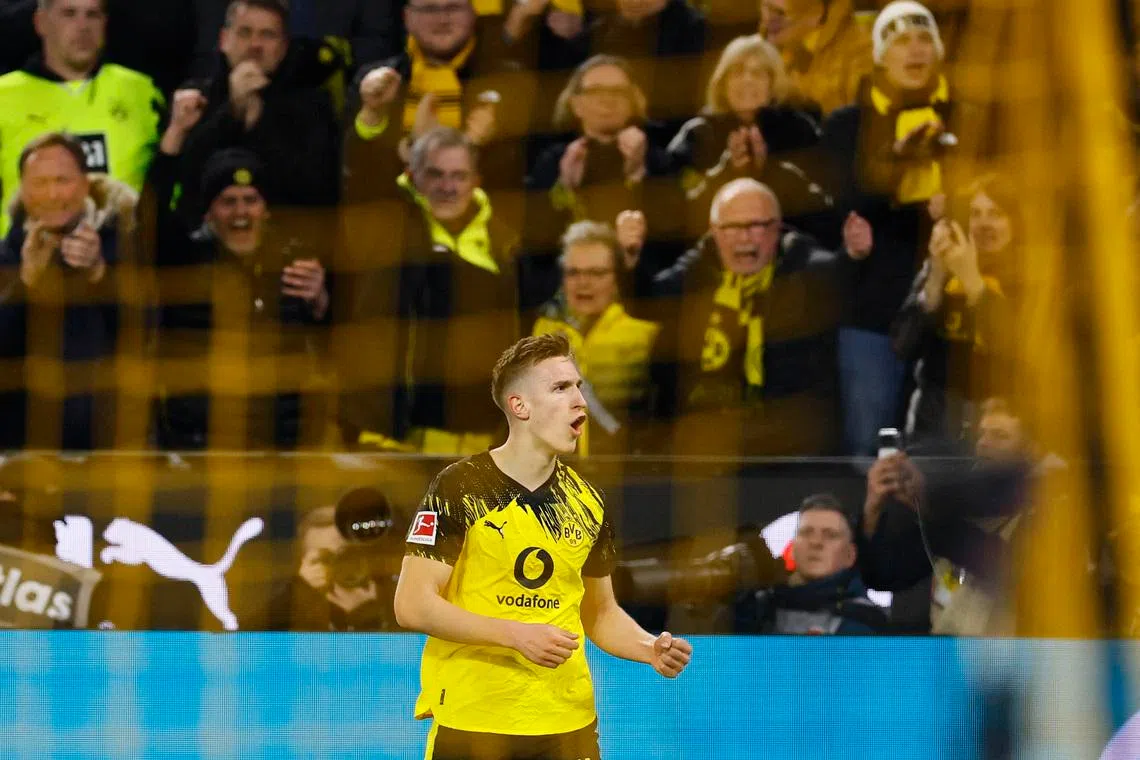 Soccer Football - Bundesliga - Borussia Dortmund v Bayern Munich - Signal Iduna Park, Dortmund, Germany - February 28, 2026 Borussia Dortmund's Nico Schlotterbeck celebrates scoring their first goal REUTERS/Wolfgang Rattay