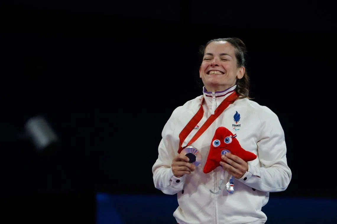 France's Sandrine Martinet celebrates after winning silver in the -48kg J2 classification in judo at the Paris Paralympics.