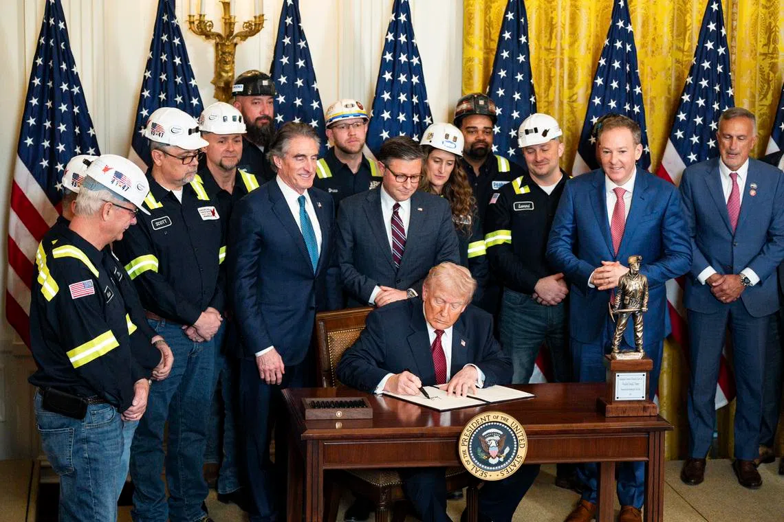 President Donald Trump signs an executive order during a coal-powered energy event at the White House on Feb 11.