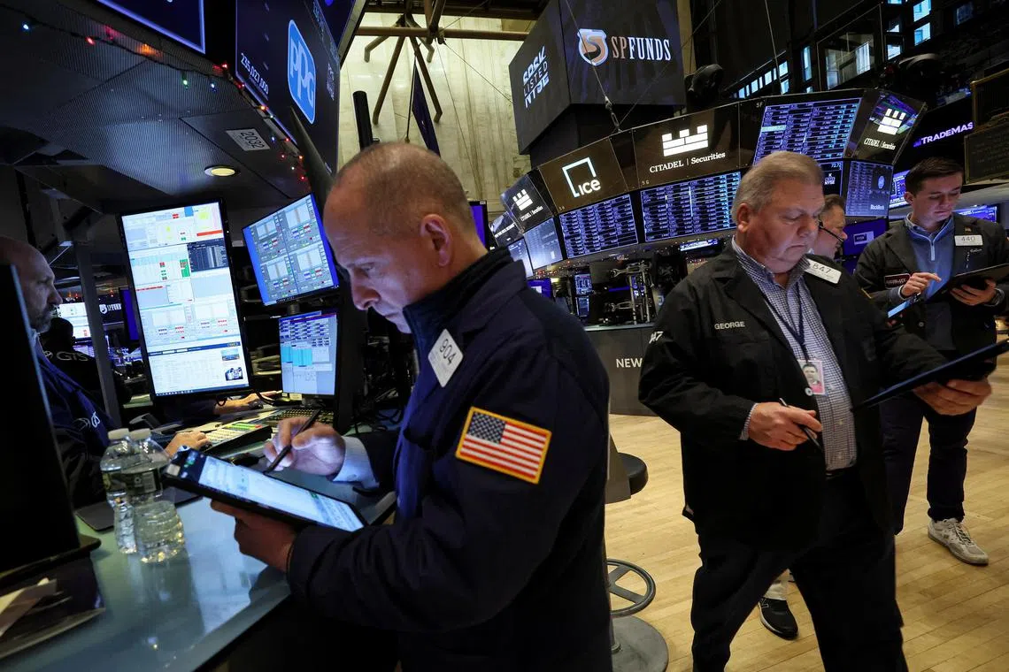 Traders work on the floor of the New York Stock Exchange. 