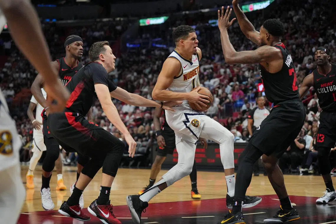 Denver Nuggets forward Michael Porter Jr. drives to the basket as Miami Heat guard Terry Rozier defends during the first half at Kaseya Centre.