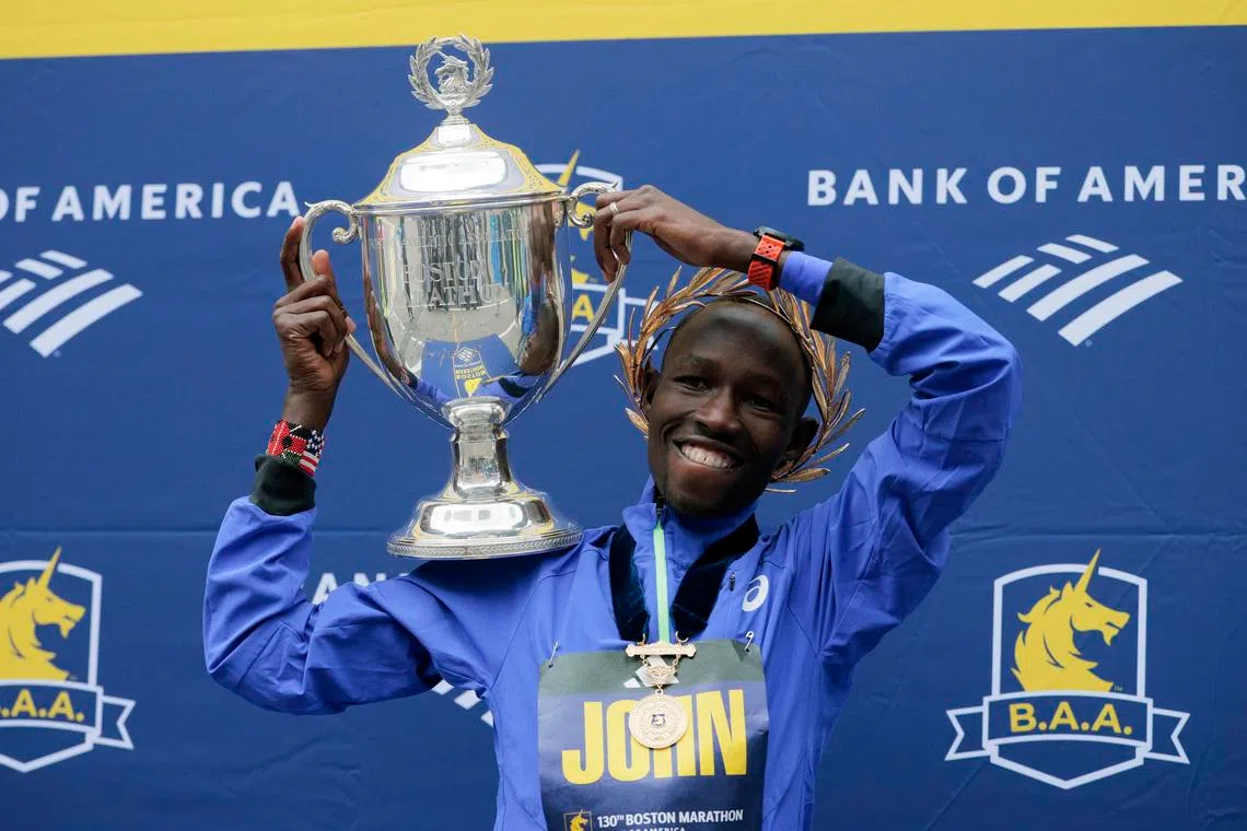 Athletics - Boston Marathon - Boston, Massachusetts, U.S. - April 20, 2026 Kenya's John Korir celebrates with a trophy after winning the men's elite race REUTERS/Brian Snyder