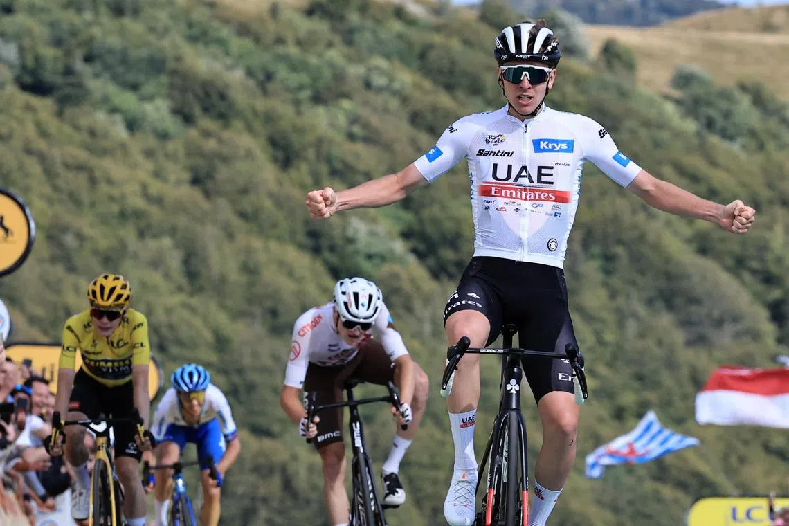 Slovenian rider Tadej Pogacar of UAE Team Emirates celebrates as he crosses the finish line to win the 20th stage of the 2023 Tour de France 2023.