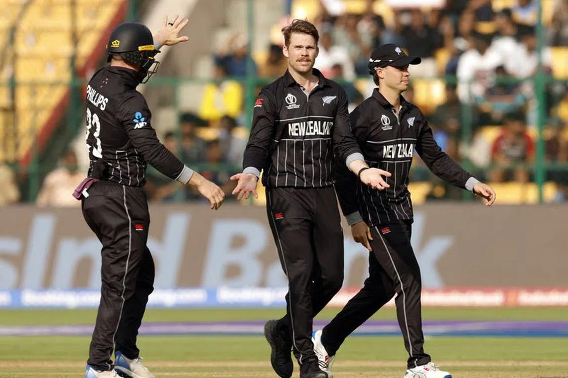 Cricket - ICC Cricket World Cup 2023 - New Zealand v Sri Lanka - M. Chinnaswamy Stadium, Bengaluru, India - November 9, 2023 New Zealand's Lockie Ferguson celebrates with teammates after taking the wicket of Sri Lanka's Chamika Karunaratne REUTERS/Adnan Abidi