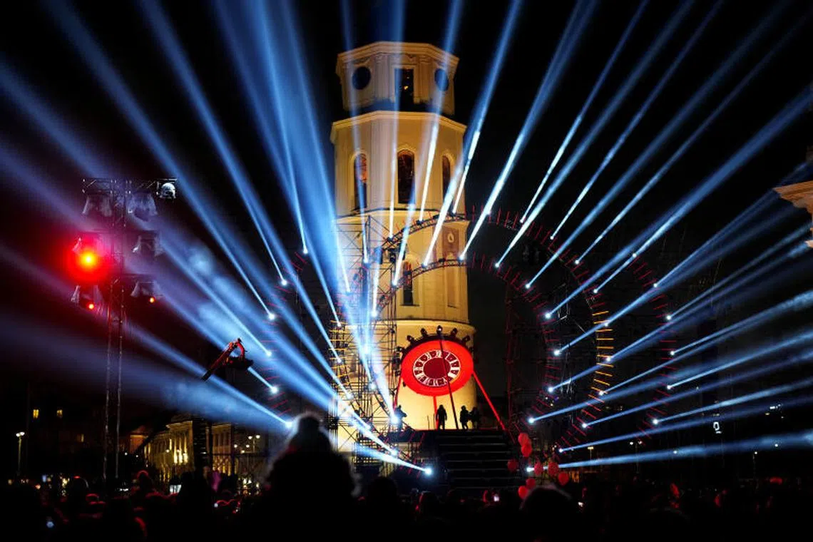 People watch light illumination during Lithuanian capital's 700th anniversary celebration with the festival of lights in Vilnius, Lithuania. PHOTO : REUTERS