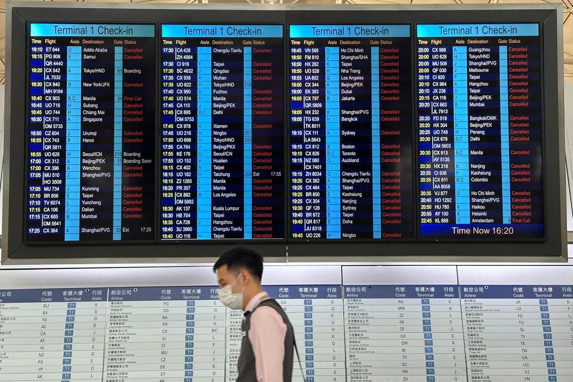 A departure board displays flight cancellations at Hong Kong International Airport, as Super Typhoon Ragasa disrupts travel, in Hong Kong, China, September 23, 2025. REUTERS/Edmond Ng