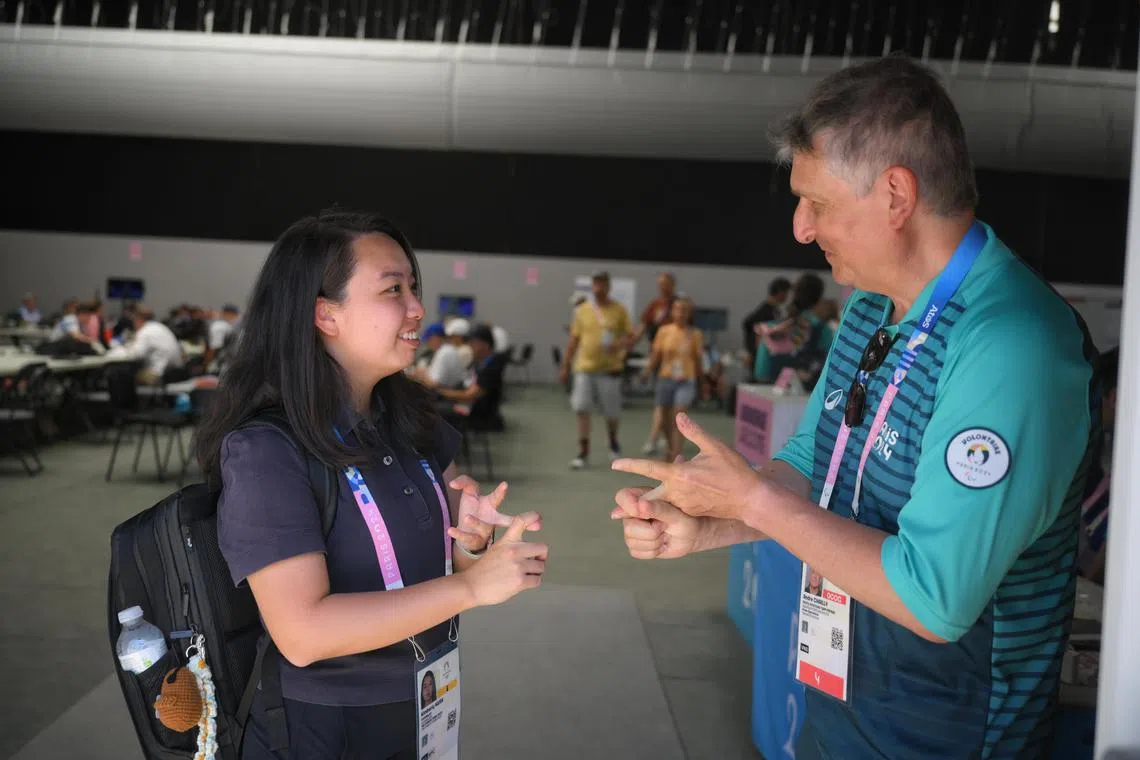 The Straits Times sports journalist Kimberly Kwek speaks to a volunteer at the Paris 2024 Olymics rowing venue at on July 29, 2024.