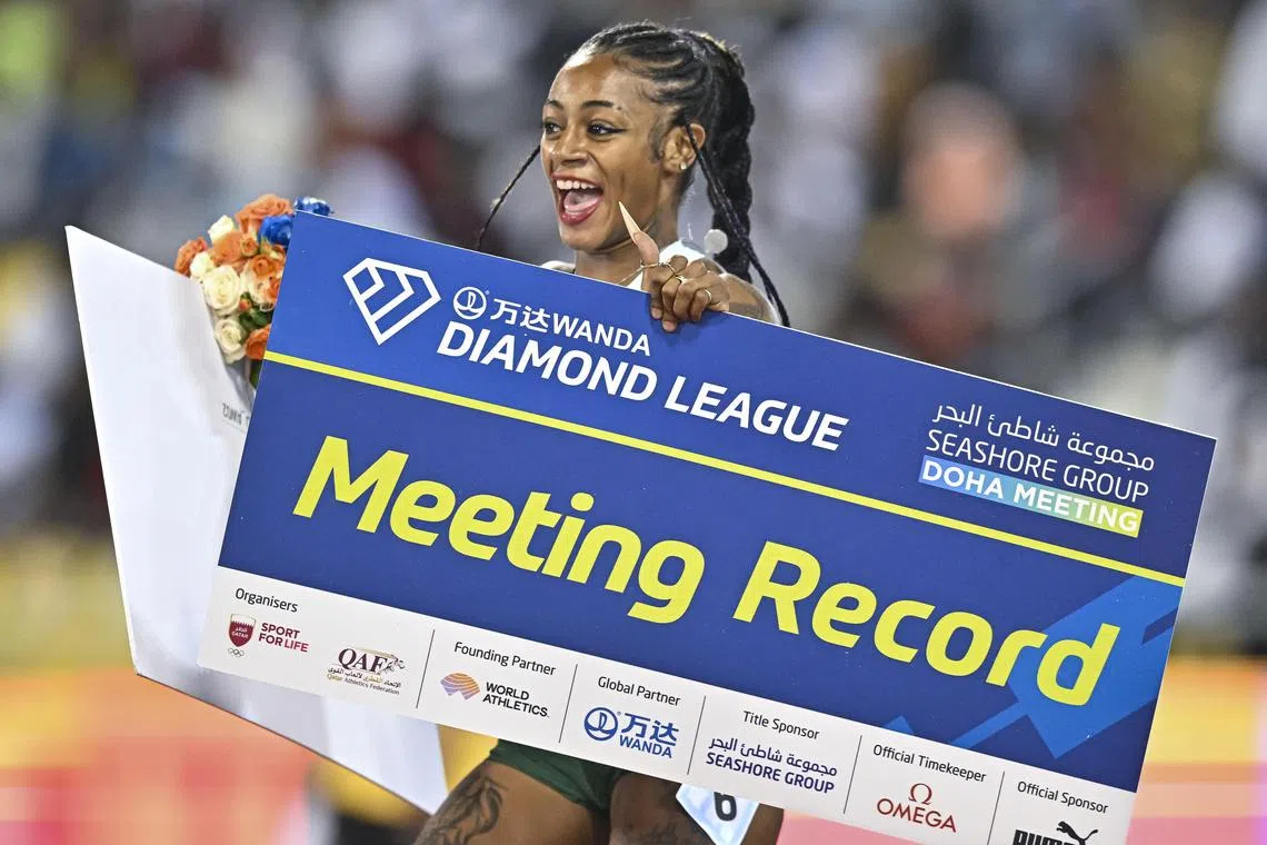 Sha'Carri Richardson celebrates after winning the women's 100m final at the Doha Diamond League meet on Friday.