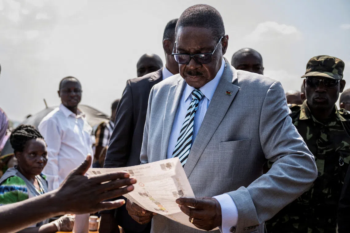 FILE PHOTO: Malawi's presidential candidate and leader of the Democratic Progressive Party Peter Mutharika inspects a ballot paper before casting his vote during the general election at Thyolo District, south of Blantyre, Malawi, September 16, 2025. REUTERS/Stringer/File Photo