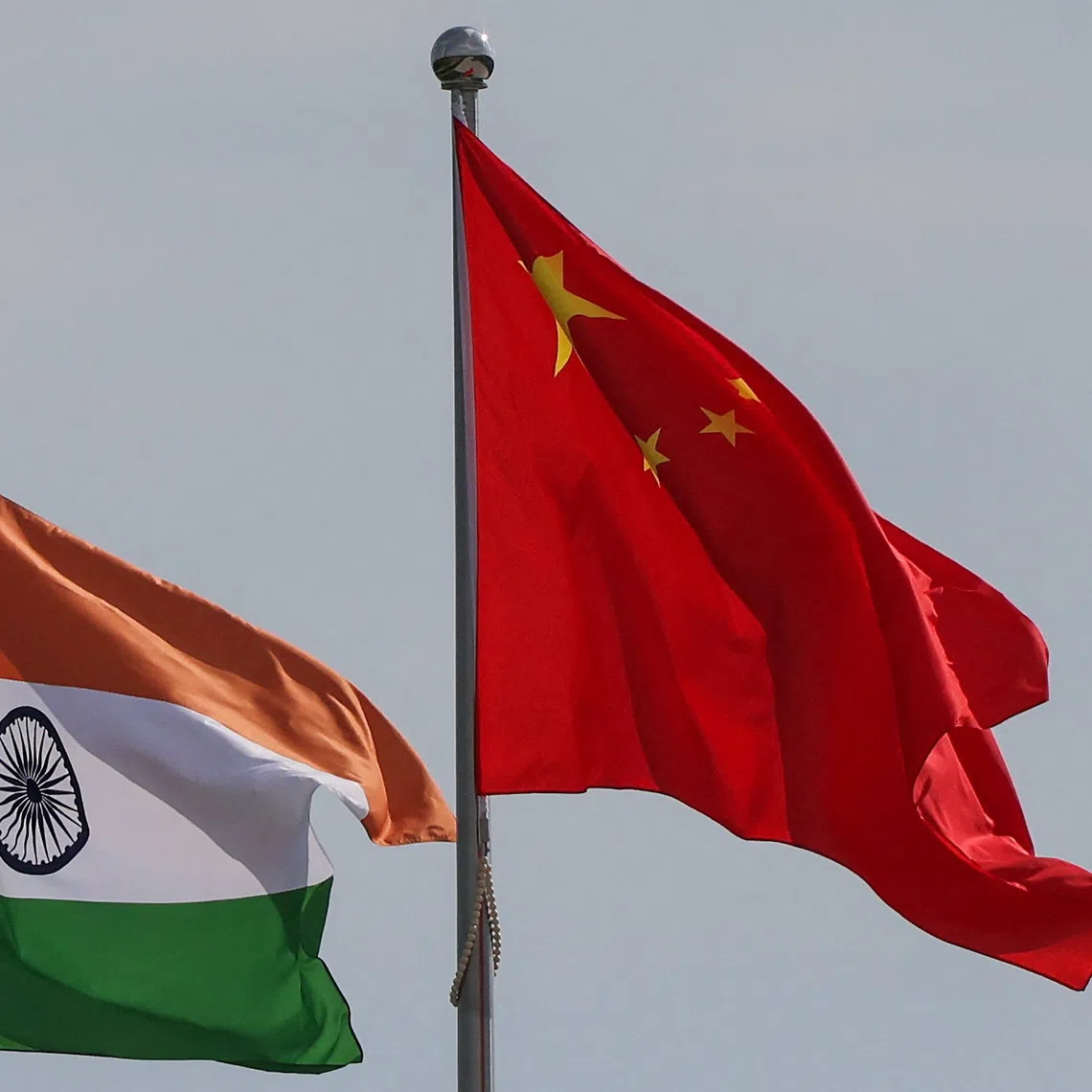 National flags of China and India fly next to the Meijiang Convention and Exhibition Center, a venue for 2025 Shanghai Cooperation Organisation (SCO) summit in Tianjin, China August 30, 2025. REUTERS/Maxim Shemetov