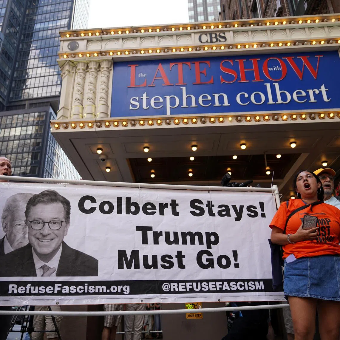 People protest after CBS/Paramount announced the cancellation of The Late Show with Stephen Colbert outside the Ed Sullivan Theater, in New York City, on July 21.