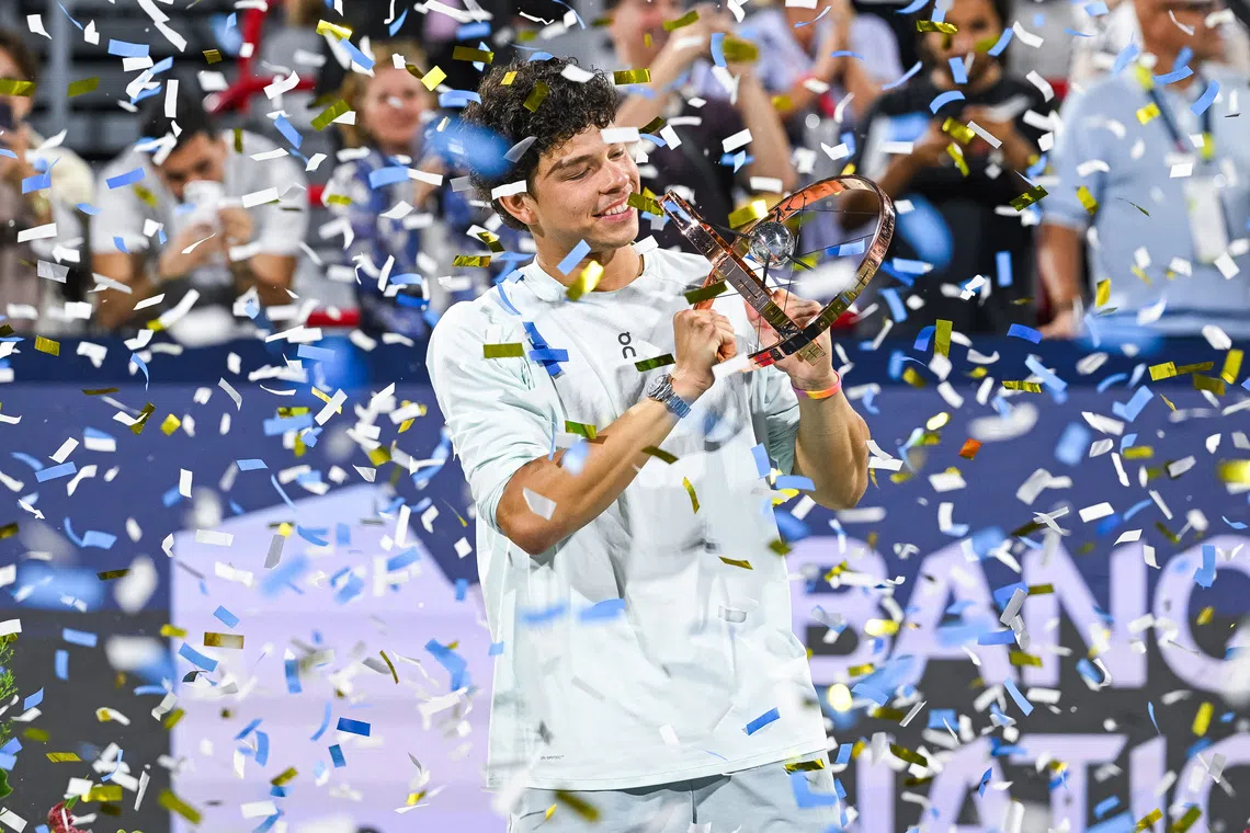 Ben Shelton celebrates with his trophy after winning the Canadian Open for a second straight year.