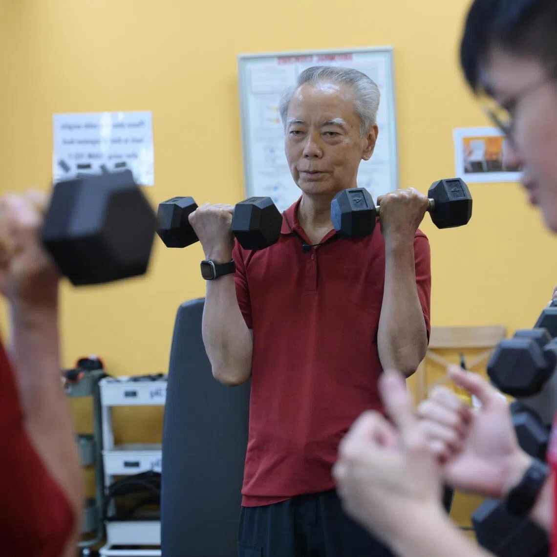 wqheart22/ST20260324_202622100975/Ng Sor Luan/Patient with atrial fibrillation Mr Tan Check Wanparticipating in a heart wellness programme by Singapore Heart Foundation at Singapore Heart Foundation Heart Wellness Centre @ Bishan. He is assisted by therapy assistant, Cheval Lim, 28. 