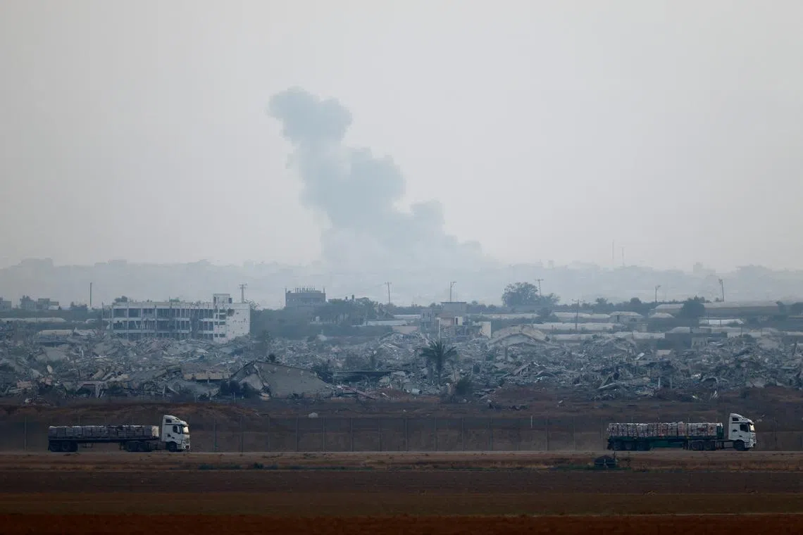 Trucks loaded with aid drive on the Israel-Gaza border as they make their way into Gaza, as seen from Israel, June 7, 2025. REUTERS/Amir Cohen