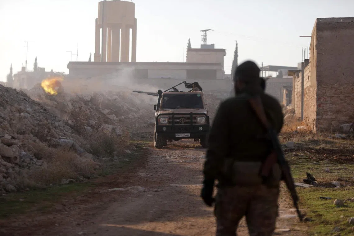 Fighters firing towards Syrian Army troops in the Rashidin district on the outskirts of Aleppo, on Nov 29.