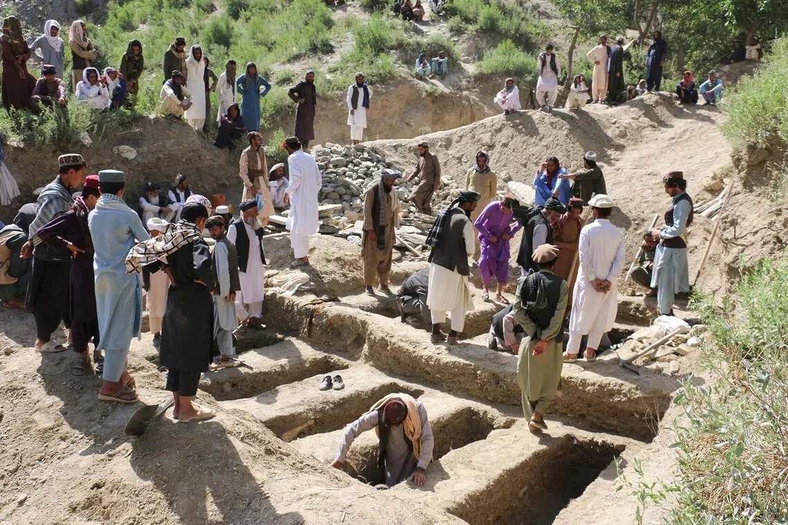 People digging graves for victims who died in what the Taliban said was a Pakistani airstrike in Mani village, Afghanistan, June 10.